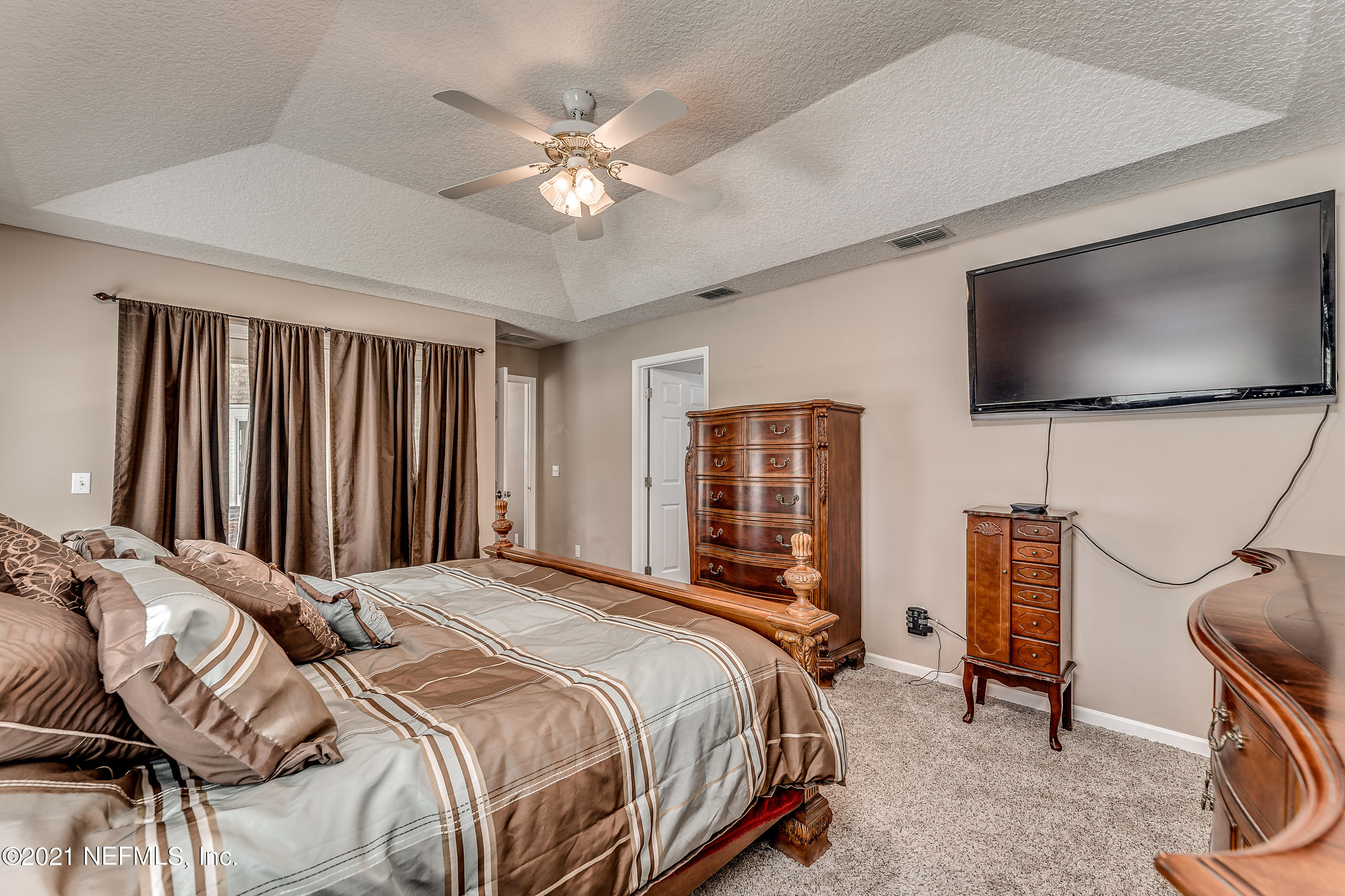 1123 Cactus Cut Road Middleburg, FL 32068 - Photo 41 of 66 a bedroom with a bed and a flat screen tv