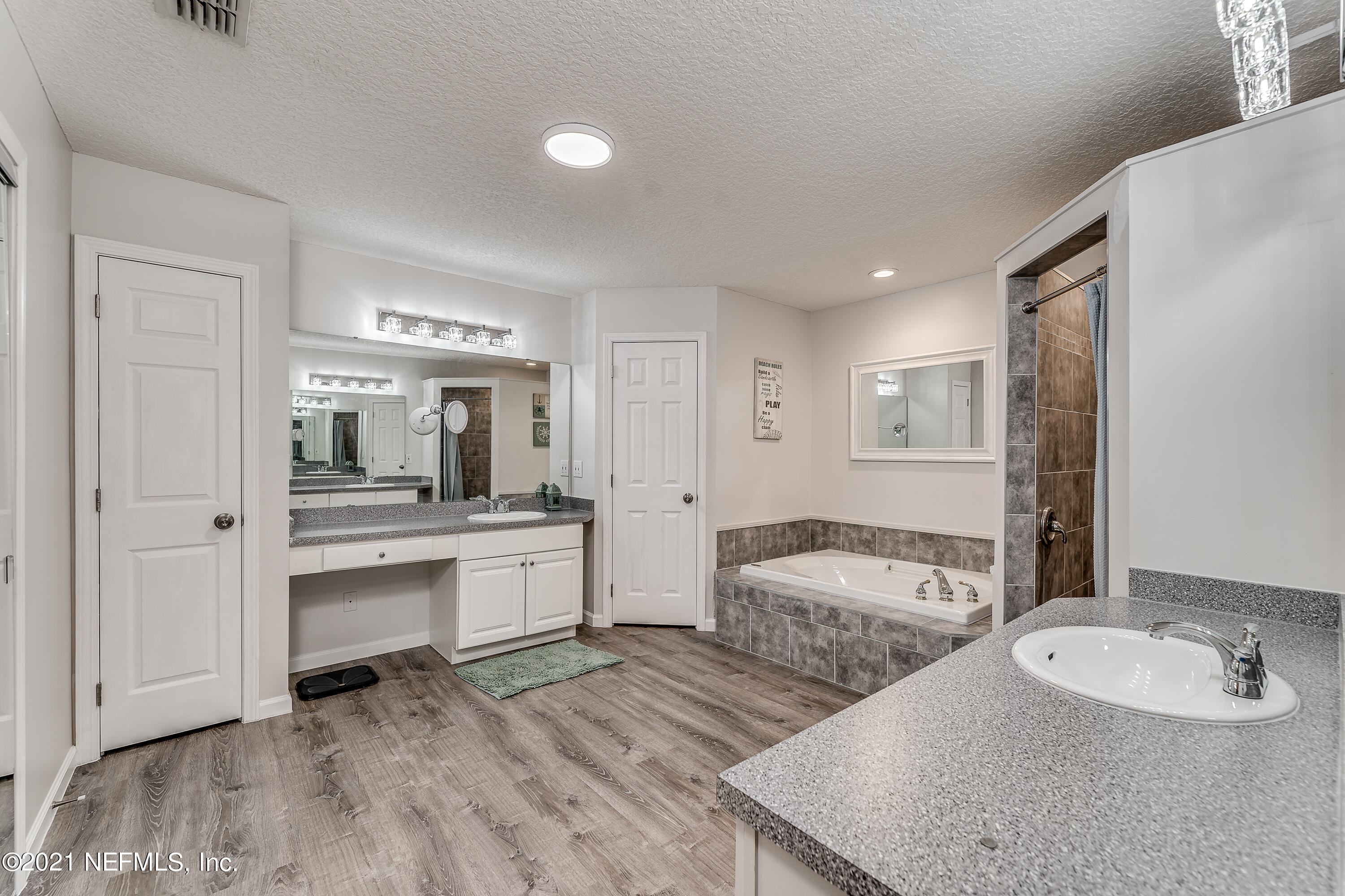 1123 Cactus Cut Road Middleburg, FL 32068 - Photo 43 of 66 a spacious bathroom with a granite countertop sink and a mirror