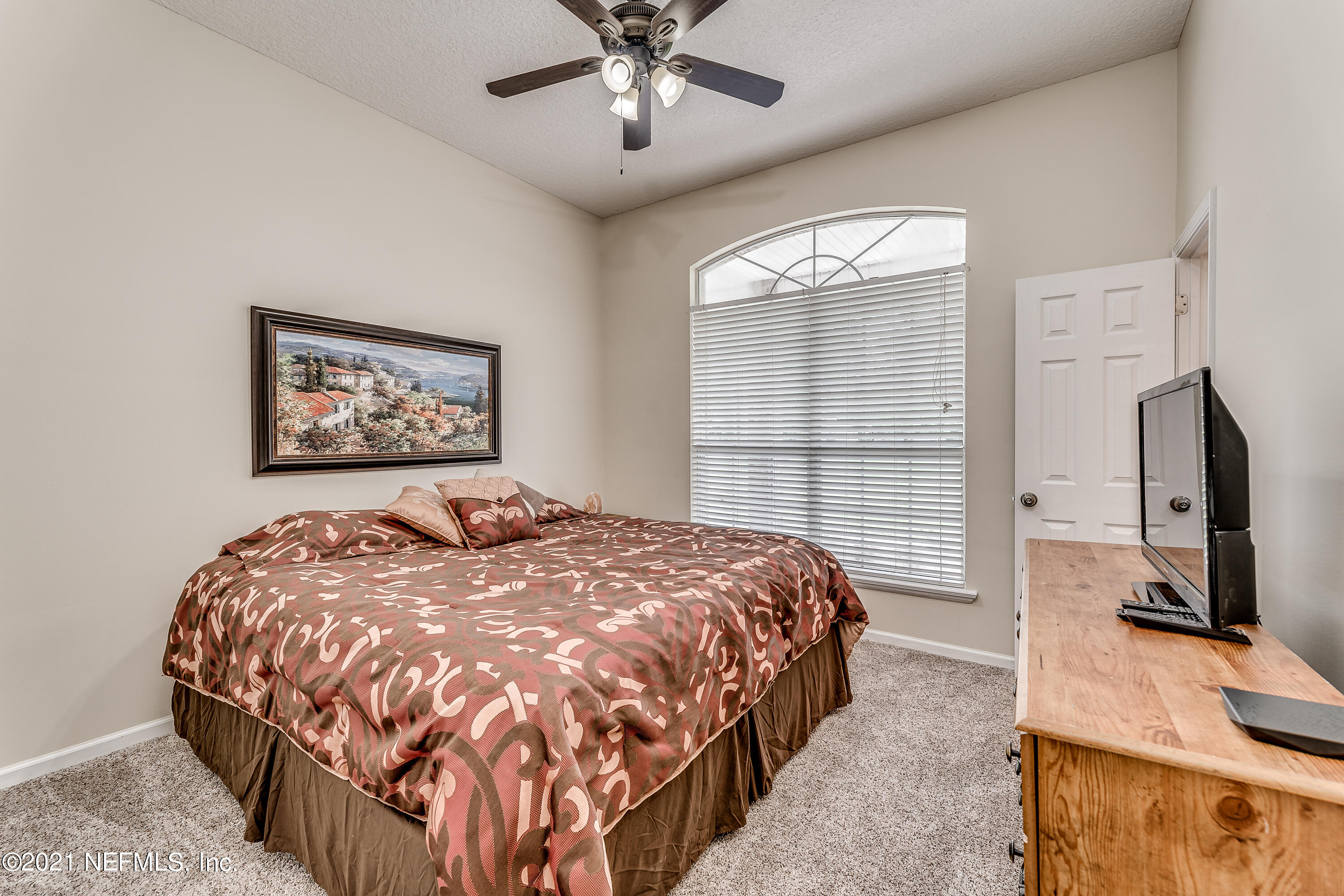 1123 Cactus Cut Road Middleburg, FL 32068 - Photo 46 of 66 a bedroom with a bed and a flat screen tv
