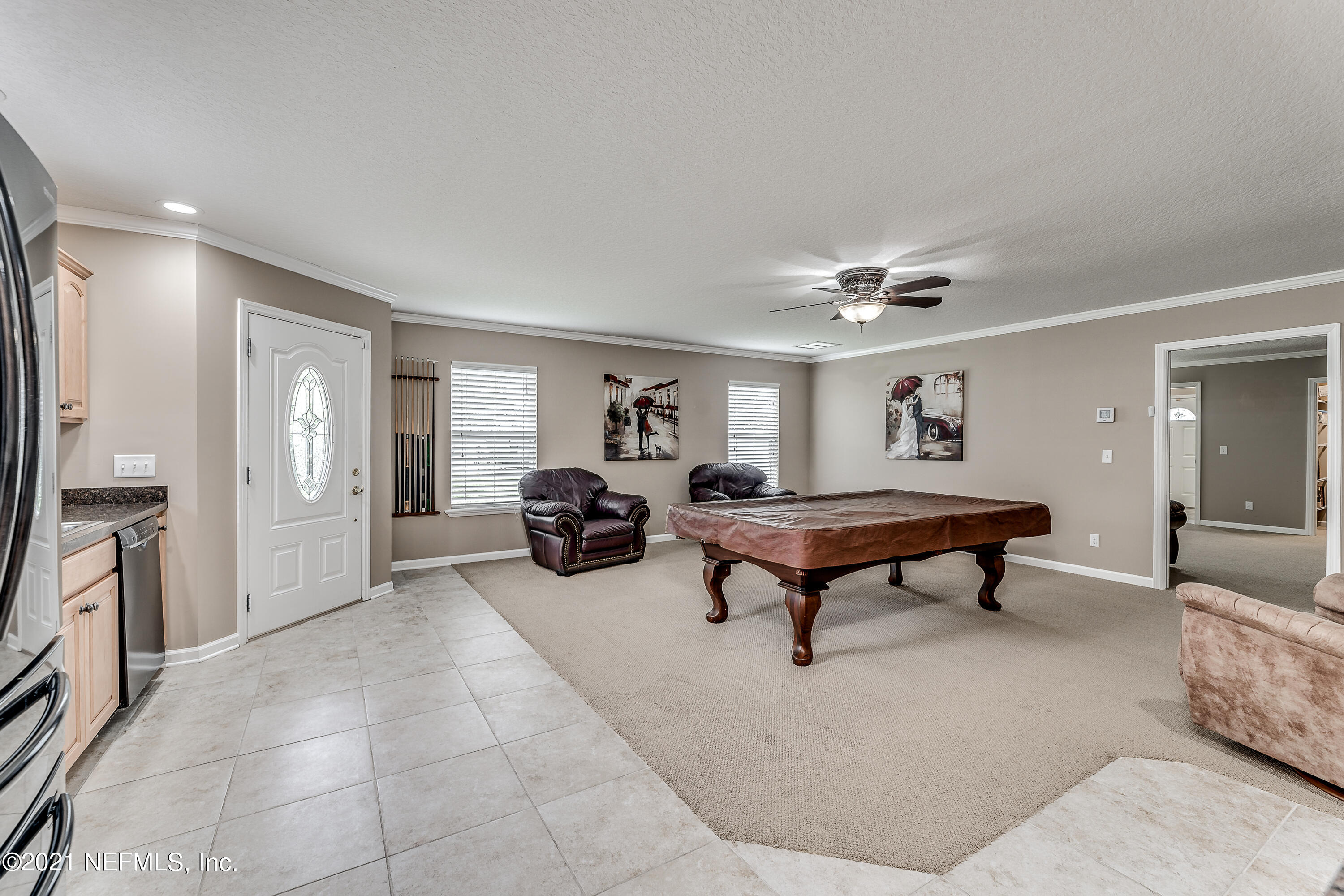 1123 Cactus Cut Road Middleburg, FL 32068 - Photo 56 of 66 a living room with furniture a rug and a chandelier