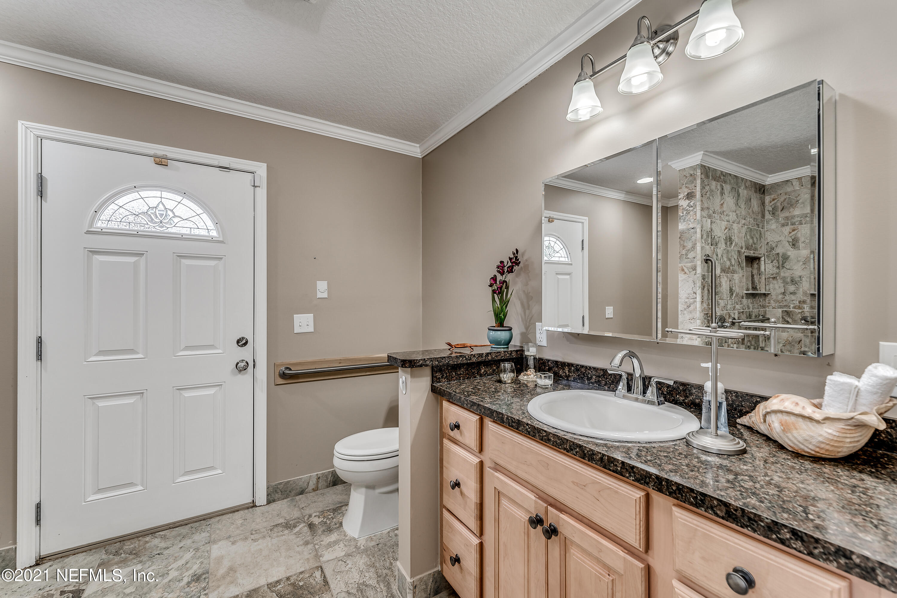 1123 Cactus Cut Road Middleburg, FL 32068 - Photo 61 of 66 a bathroom with a granite countertop sink a toilet and a mirror
