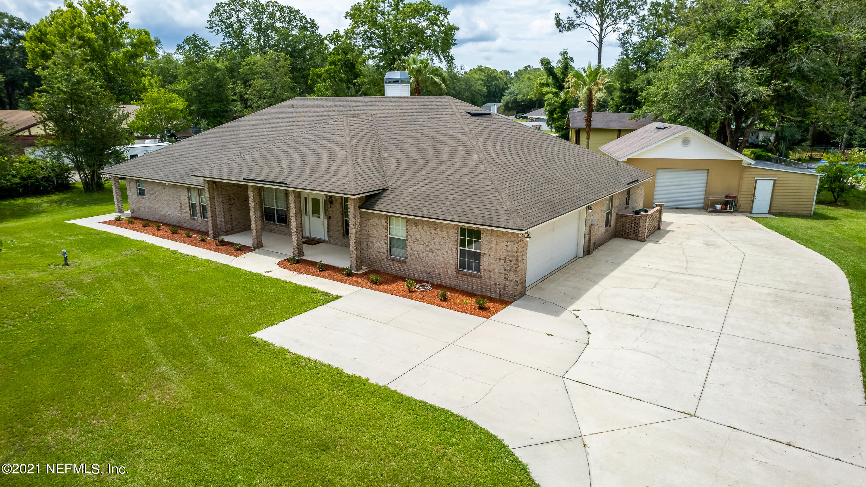 1123 Cactus Cut Road Middleburg, FL 32068 - Photo 7 of 66 a aerial view of a house with table and chairs under an umbrella