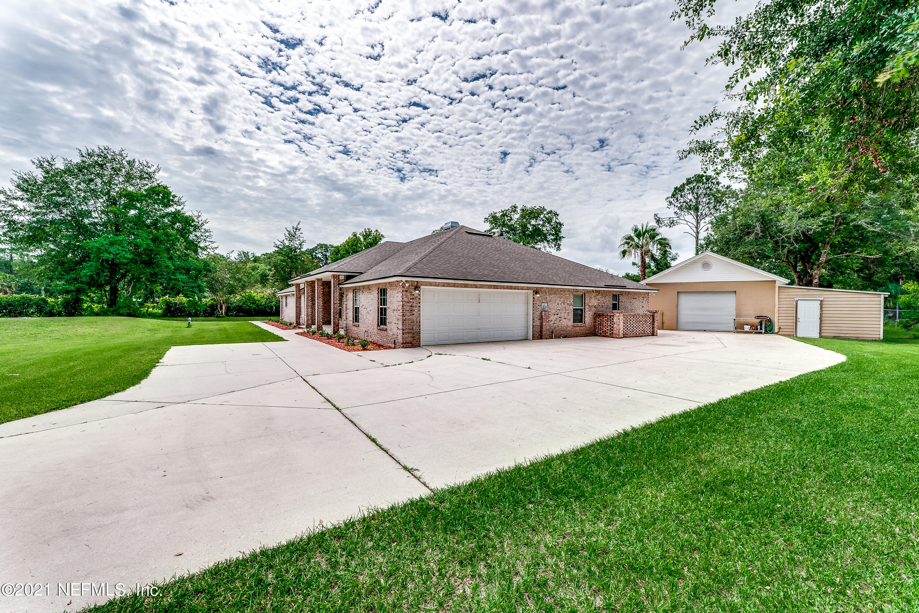 1123 Cactus Cut Road Middleburg, FL 32068 - Photo 10 of 66 a front view of a house with a yard and large tree
