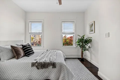 a bedroom with a bed and a window