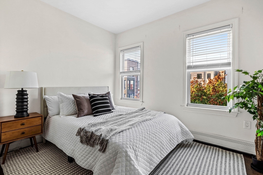 296 East 8th Street, Unit 3 Boston, MA 02127 - Photo 14 of 29 a large bed sitting in a bedroom next to a window