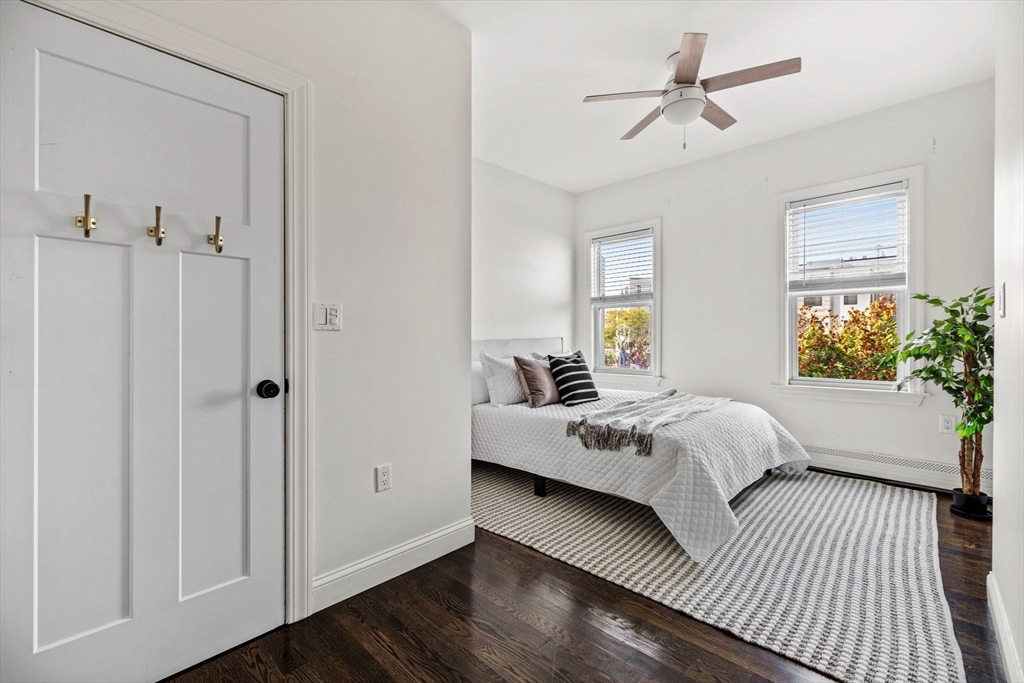 296 East 8th Street, Unit 3 Boston, MA 02127 - Photo 15 of 29 a bedroom with a bed and wooden floor