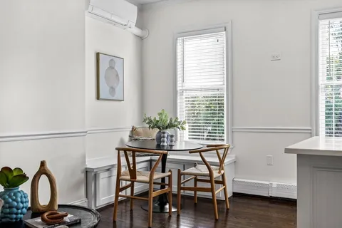a dining room with furniture and window