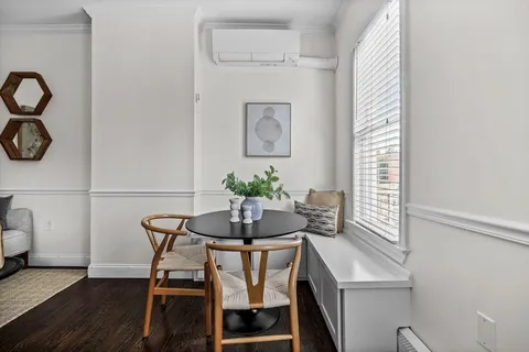 a dining room with furniture and window