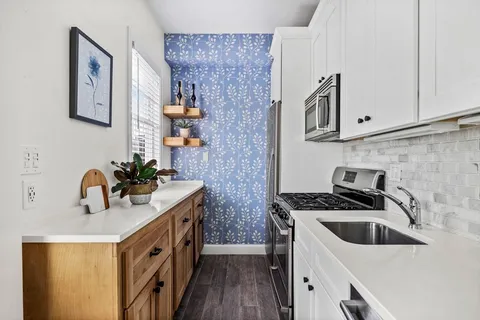a kitchen that has a sink and a stove