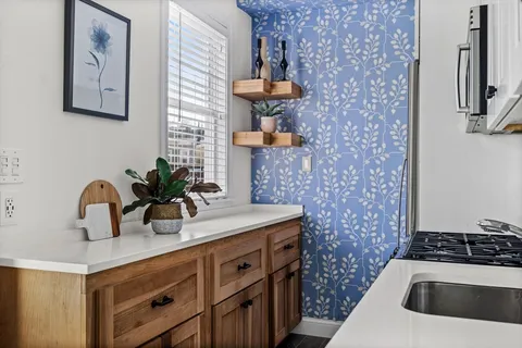a kitchen with stainless steel appliances a stove and a sink