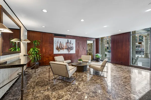 a living room with furniture and a potted plant