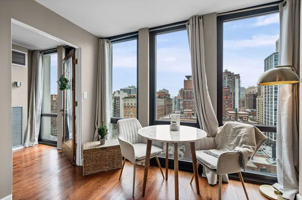 a view of a dining room with furniture and wooden floor