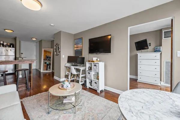 a living room with furniture and a flat screen tv
