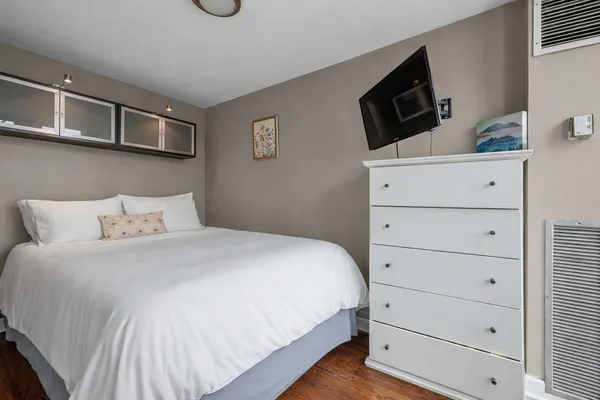 a bedroom with a bed and flat screen tv