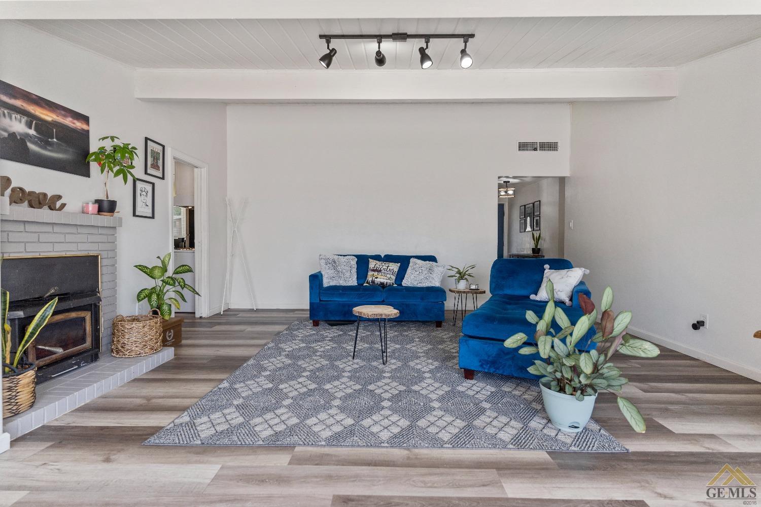 Undisclosed Address Bakersfield, CA 93305 - Photo 13 of 33 a living room with furniture and a fireplace