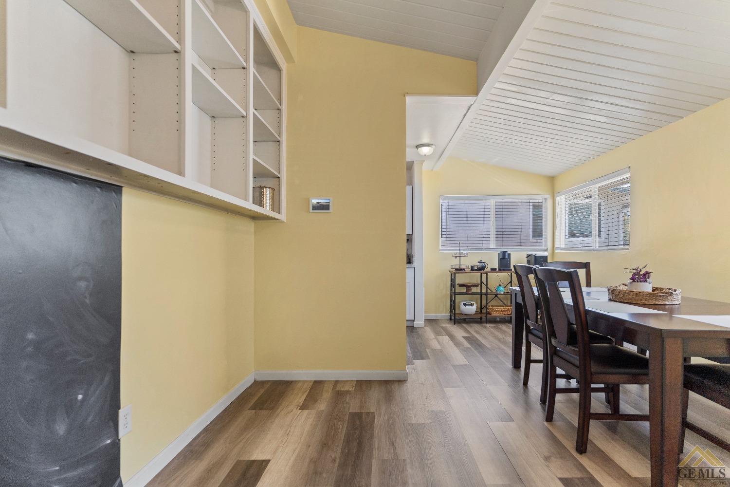 Undisclosed Address Bakersfield, CA 93305 - Photo 16 of 33 a view of a dining room with furniture and wooden floor