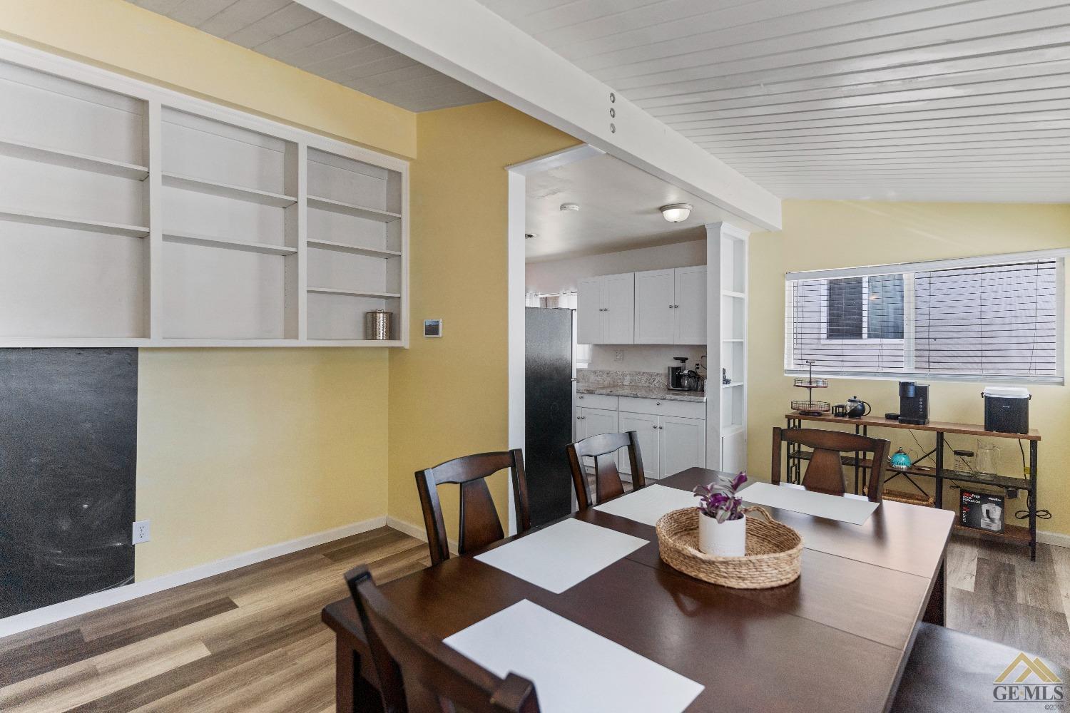 Undisclosed Address Bakersfield, CA 93305 - Photo 18 of 33 a dining room with furniture and wooden floor