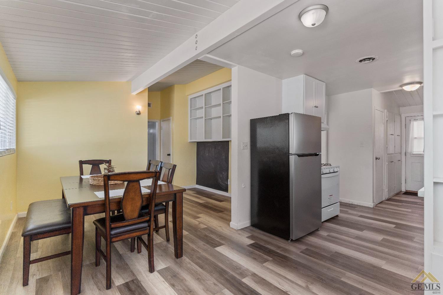Undisclosed Address Bakersfield, CA 93305 - Photo 19 of 33 a view of a dining room with furniture and wooden floor