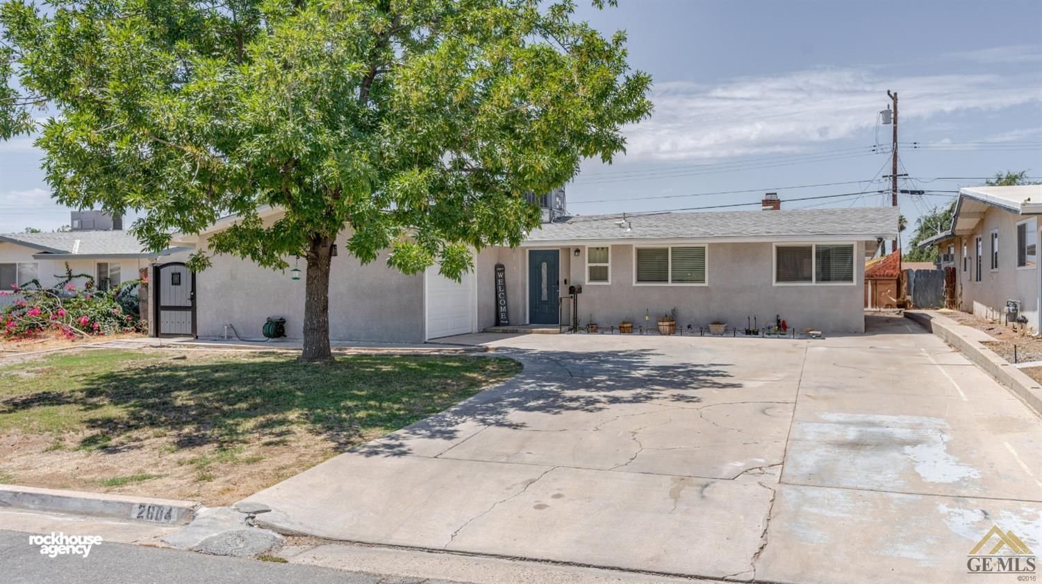 Undisclosed Address Bakersfield, CA 93305 - Photo 2 of 33 a front view of a house with a yard