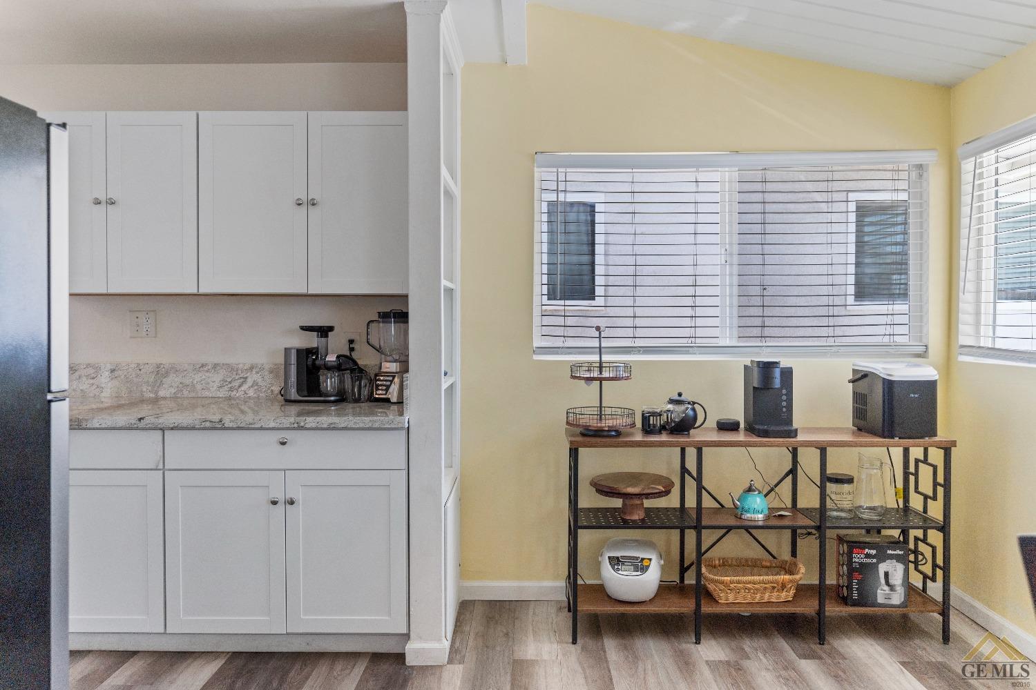 Undisclosed Address Bakersfield, CA 93305 - Photo 22 of 33 a room with table chairs and wooden floor