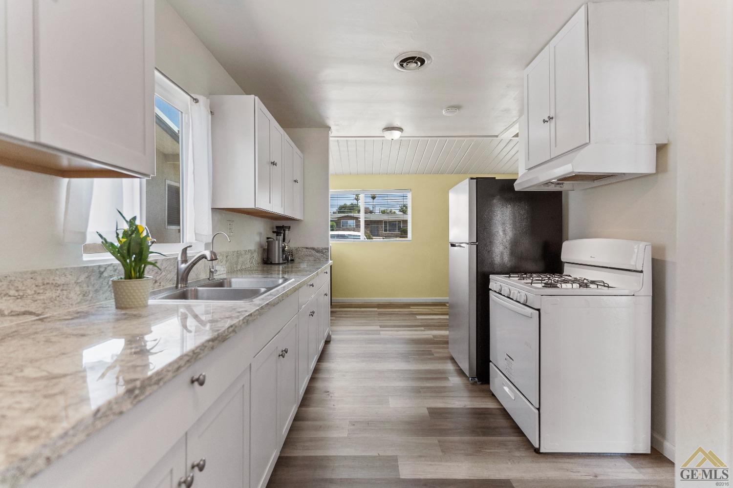 Undisclosed Address Bakersfield, CA 93305 - Photo 26 of 33 a kitchen with stainless steel appliances sink refrigerator and cabinets