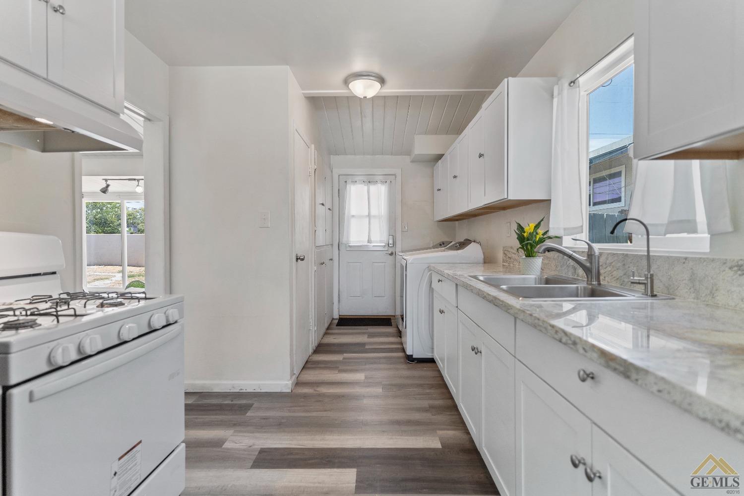 Undisclosed Address Bakersfield, CA 93305 - Photo 27 of 33 a kitchen with granite countertop a sink stove and cabinets