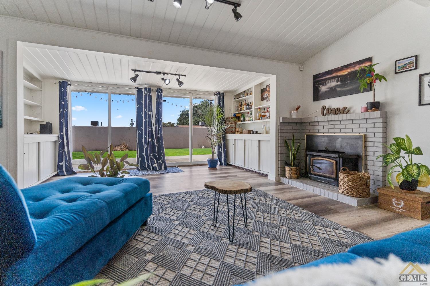 Undisclosed Address Bakersfield, CA 93305 - Photo 29 of 33 a living room with furniture a fireplace and a table