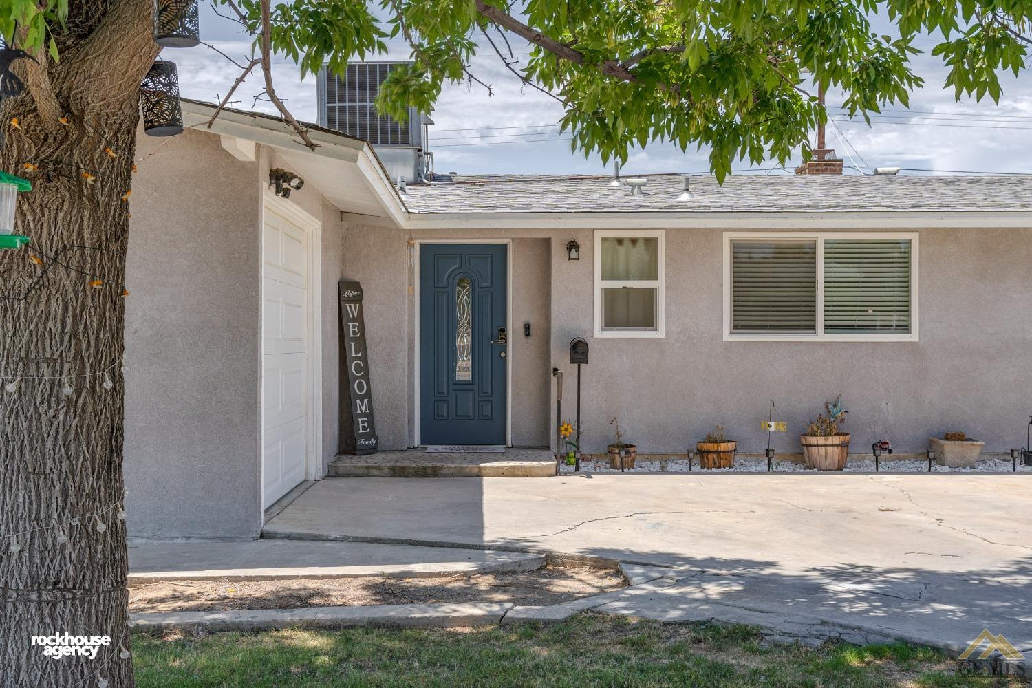Undisclosed Address Bakersfield, CA 93305 - Photo 3 of 33 a front view of a house with a yard