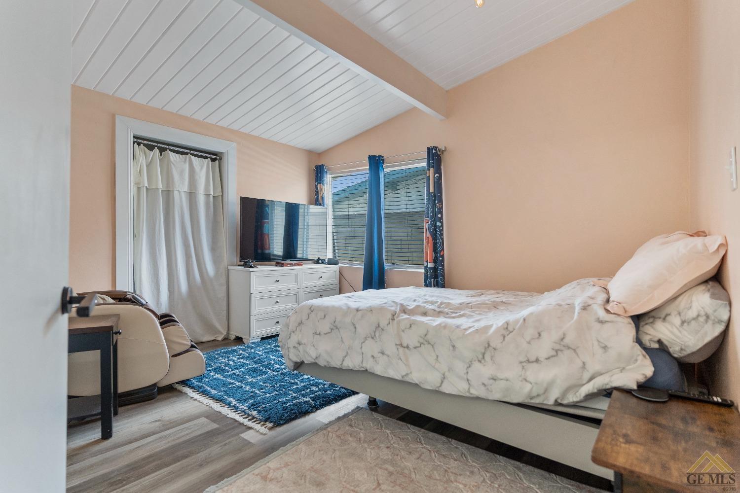 Undisclosed Address Bakersfield, CA 93305 - Photo 32 of 33 a bedroom with a bed and wooden floor