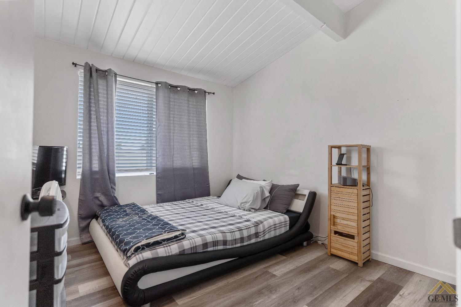 Undisclosed Address Bakersfield, CA 93305 - Photo 33 of 33 a bedroom with a bed and wooden floor