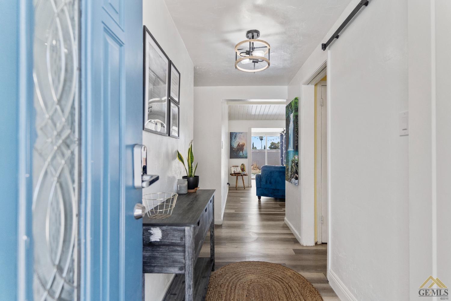 Undisclosed Address Bakersfield, CA 93305 - Photo 4 of 33 a view of a hallway with workspace and wooden floor