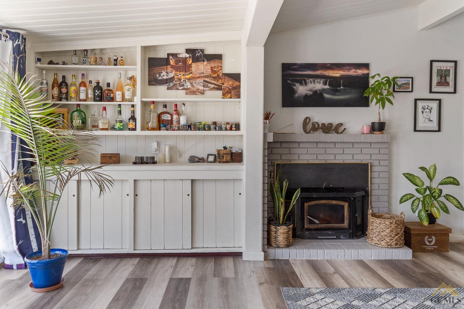Undisclosed Address Bakersfield, CA 93305 - Photo 10 of 33 a living room with lots of books and a fireplace