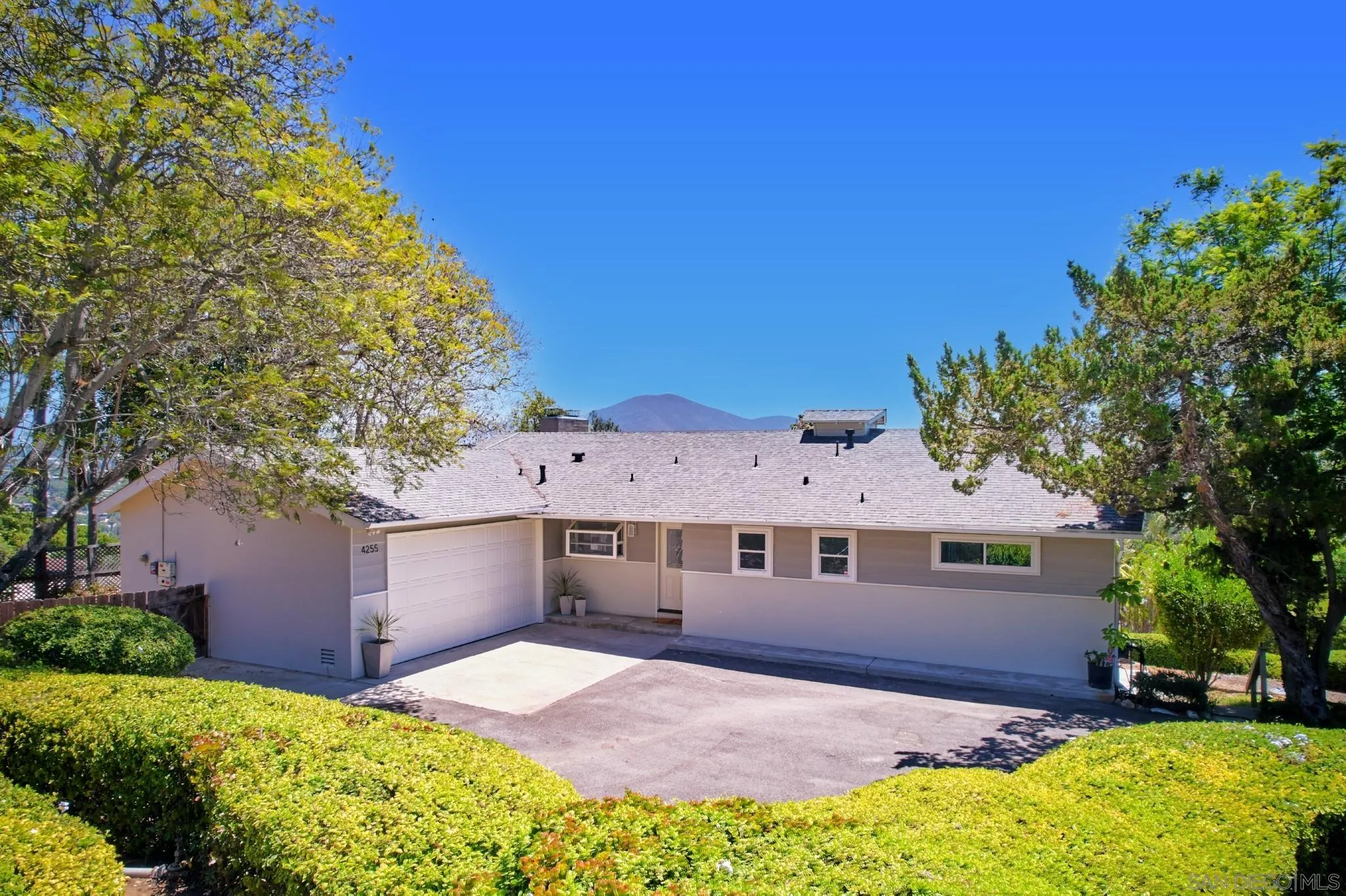 4255 North Rogers Road Spring Valley, CA 91977 - Photo 1 of 1 a front view of a house with a yard and garage