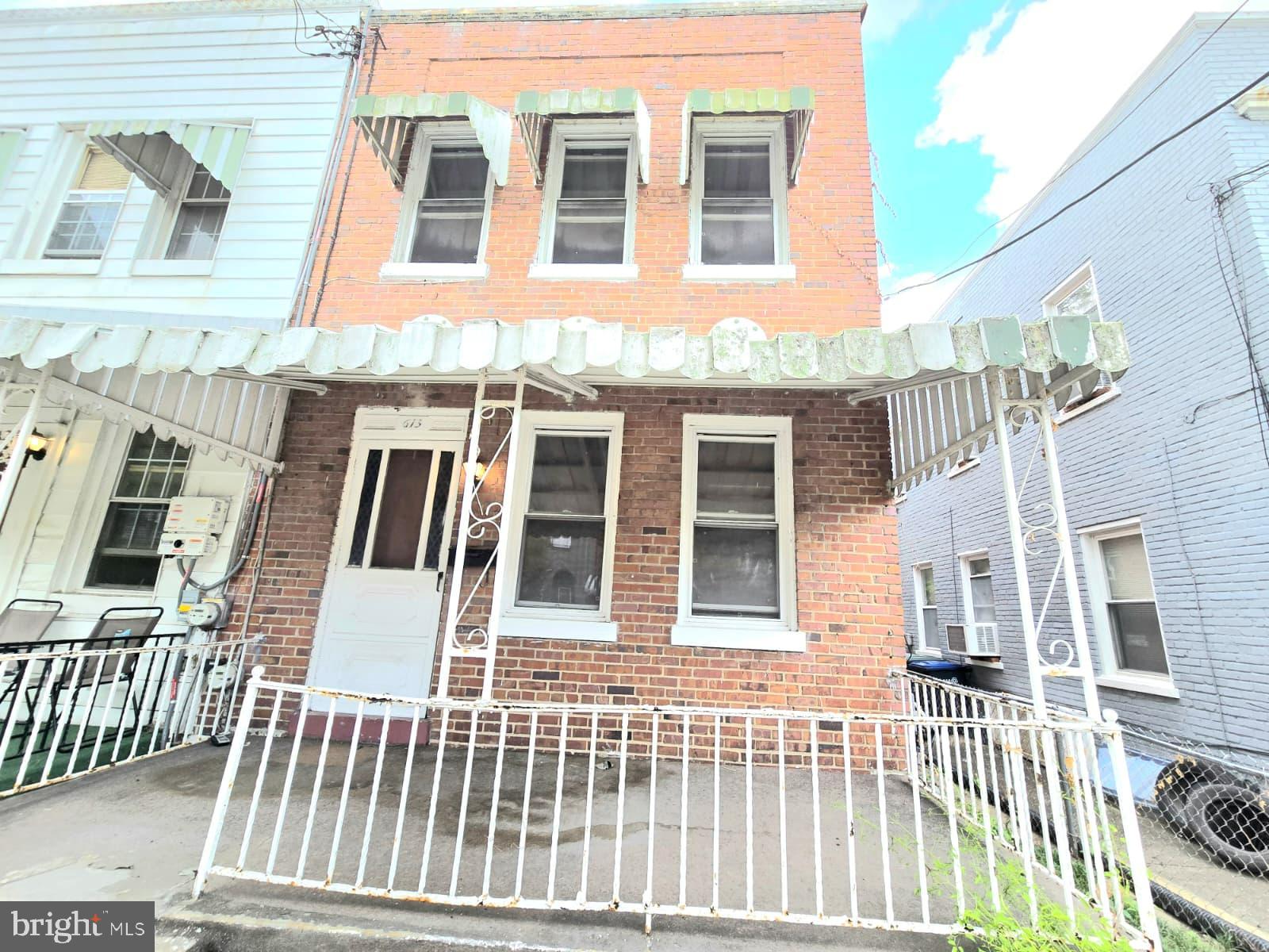 613 Roxboro Place Northwest Washington, DC 20011 - Photo 1 of 17 a view of a brick building next to a yard