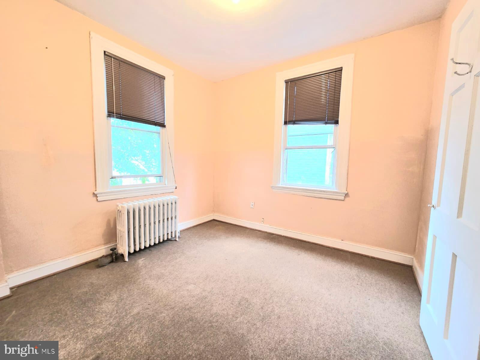 613 Roxboro Place Northwest Washington, DC 20011 - Photo 13 of 17 an empty room with a window and a ceiling fan