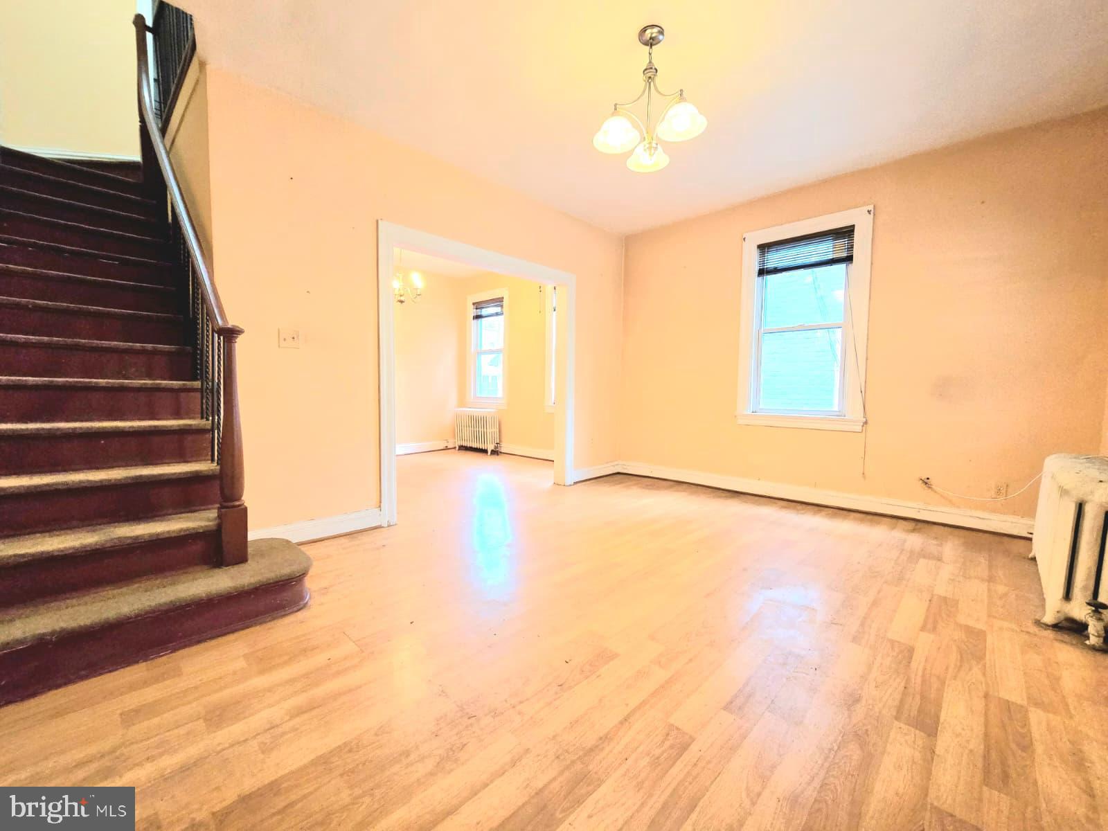 613 Roxboro Place Northwest Washington, DC 20011 - Photo 4 of 17 a view of an empty room with wooden floor and a window