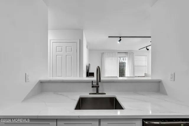 a kitchen with a sink cabinets and window