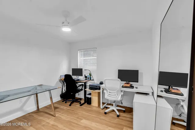 a view of a workspace with furniture and a window