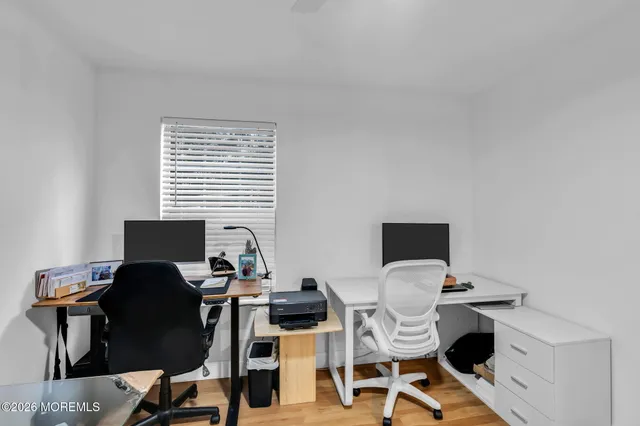 a view of a workspace with a table and chairs
