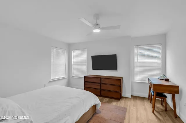 a bedroom with furniture and a flat screen tv