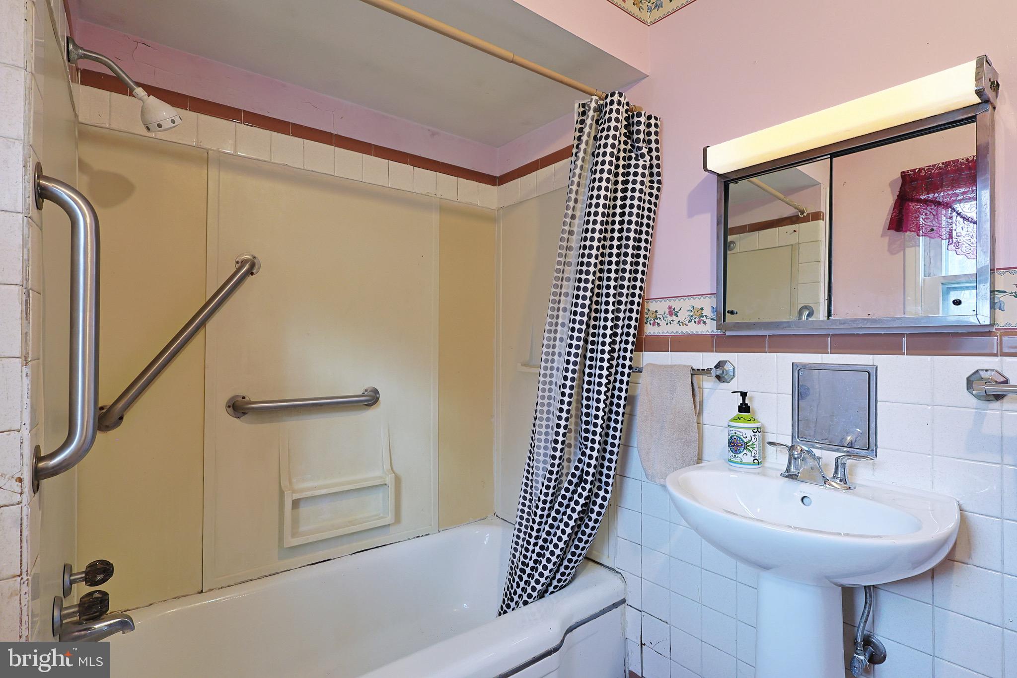 159 Rocket Center Road Keyser, WV 26726 - Photo 33 of 64 a bathroom with a sink a mirror and a shower