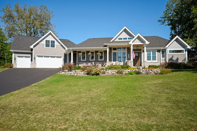 a front view of a house with a yard and fountain