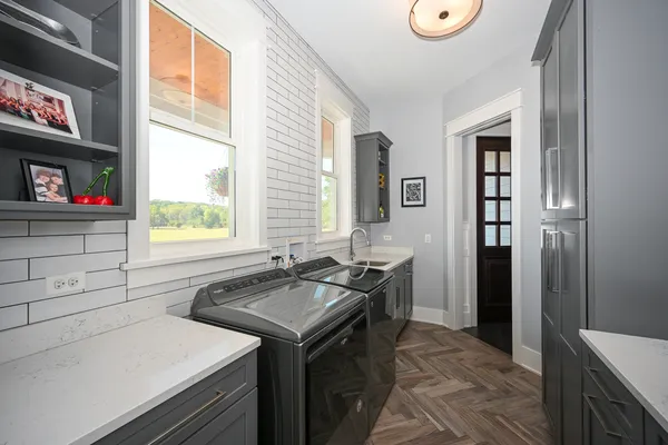 a bathroom with a double vanity sink mirror double and shower