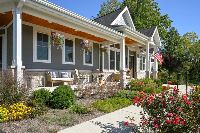 a large kitchen with granite countertop a stove a sink a dining table and chairs