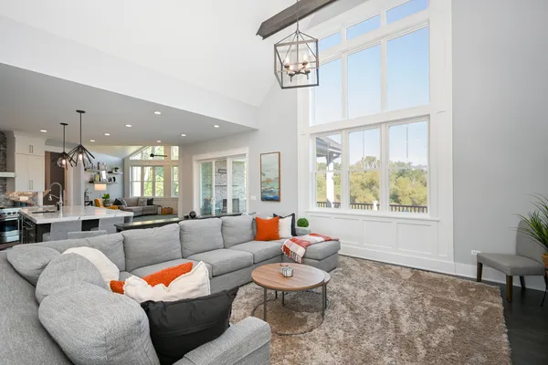 a large kitchen with granite countertop a stove a sink a dining table and chairs