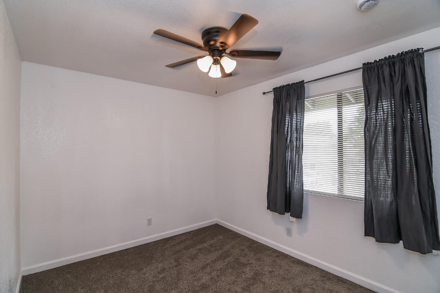1139 Rivara Circle Sacramento, CA 95864 - Photo 28 of 72 an empty room with wooden floor and a ceiling fan