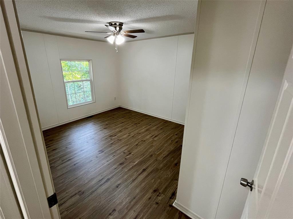 6913 Rice Road Shreveport, LA 71129 - Photo 21 of 26 wooden floor in an empty room with a window
