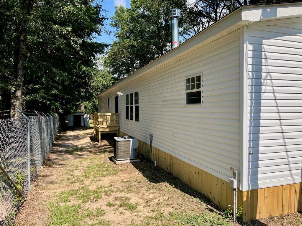 6913 Rice Road Shreveport, LA 71129 - Photo 24 of 26 a view of a backyard with large trees and a wooden fence