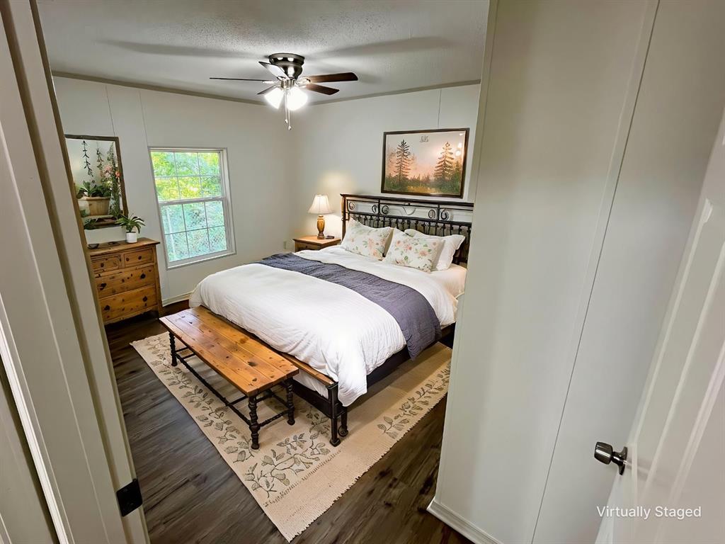 6913 Rice Road Shreveport, LA 71129 - Photo 10 of 26 a bedroom with a bed dresser and a window