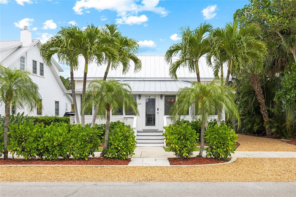 340 Palm Avenue Boca Grande, FL 33921 - Photo 3 of 38 front view of a house with a garden